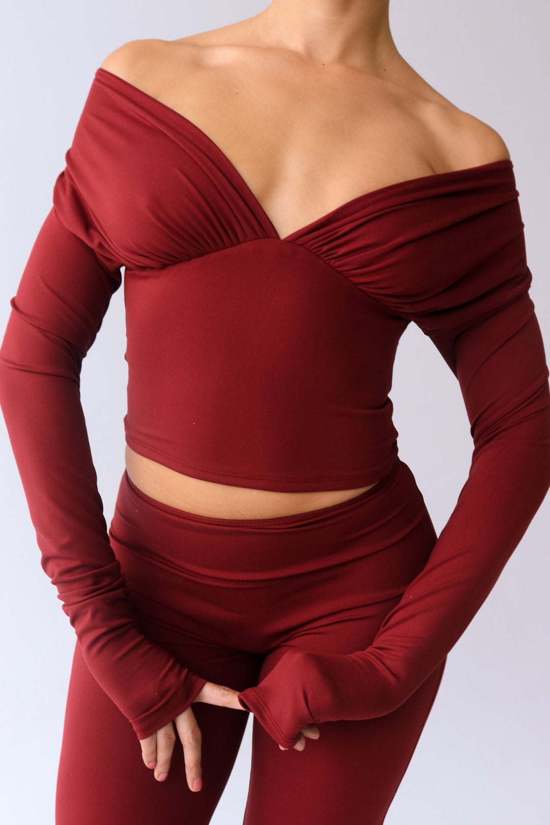 Red off-shoulder top and pants on a plain background
